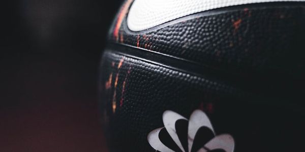 Close up of sports equipment on a dark wooden floor